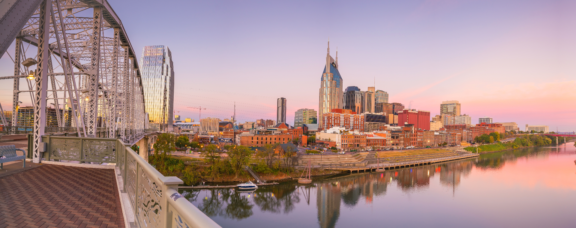 A bridge over a body of water with a city in the background.