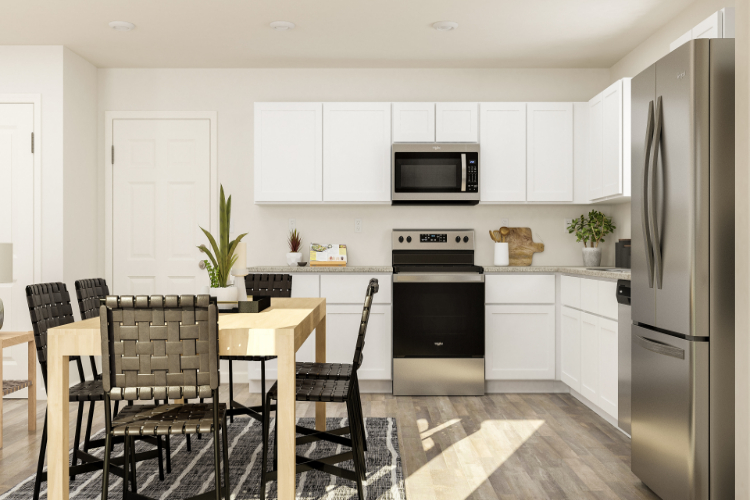 A kitchen with white cabinets.