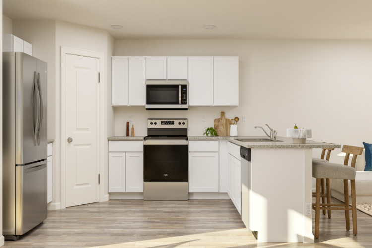 A kitchen with white cabinets.