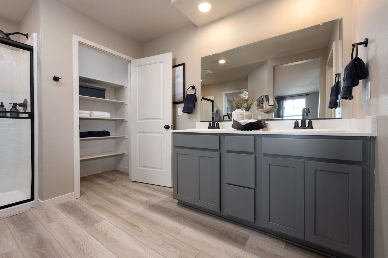 A bathroom with white cabinets.
