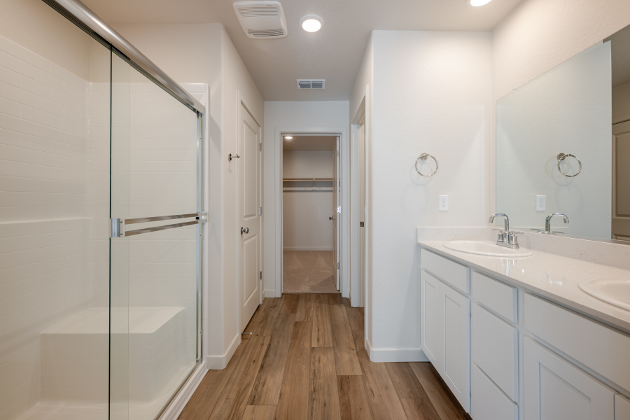A bathroom with white cabinets.