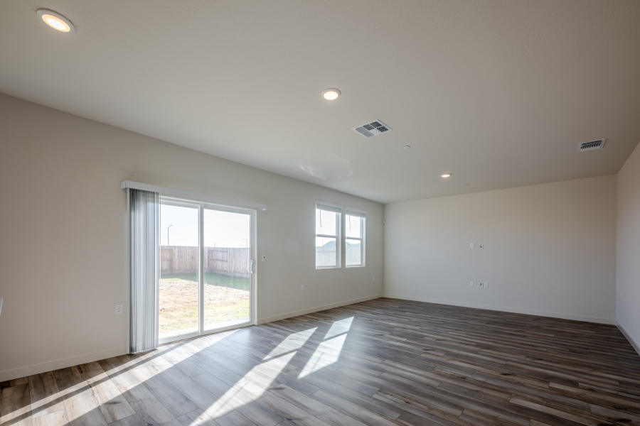 A room with a wood floor and a glass door.
