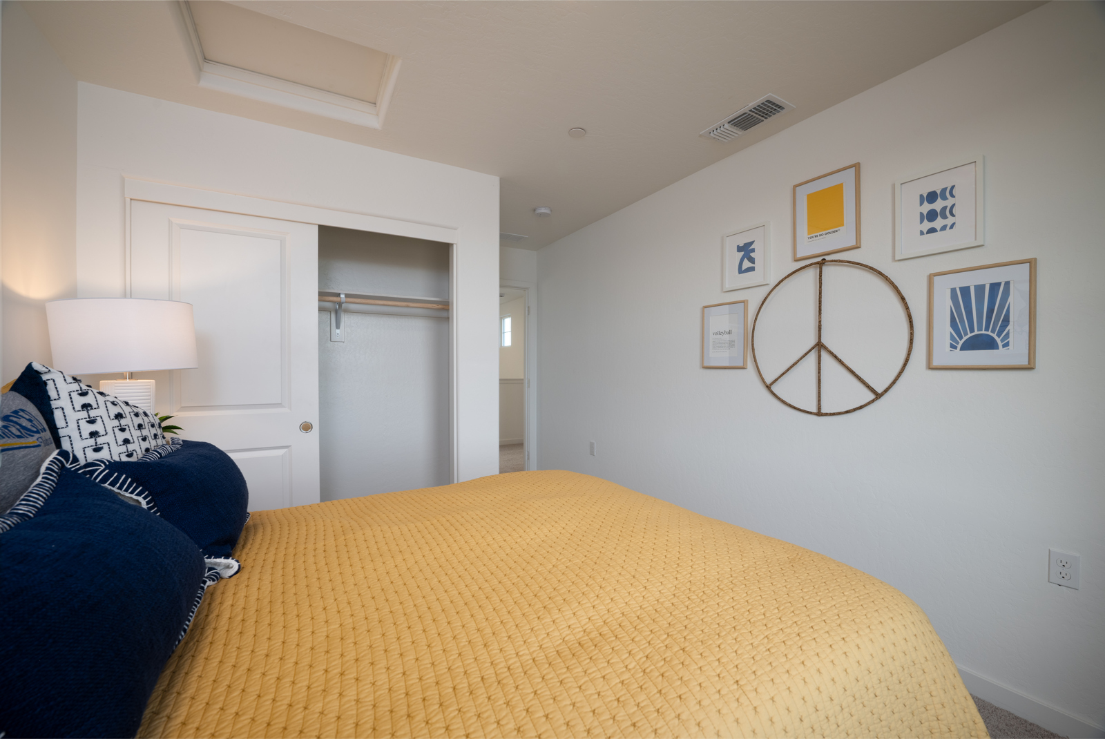 A bedroom with a mirror and a bed.