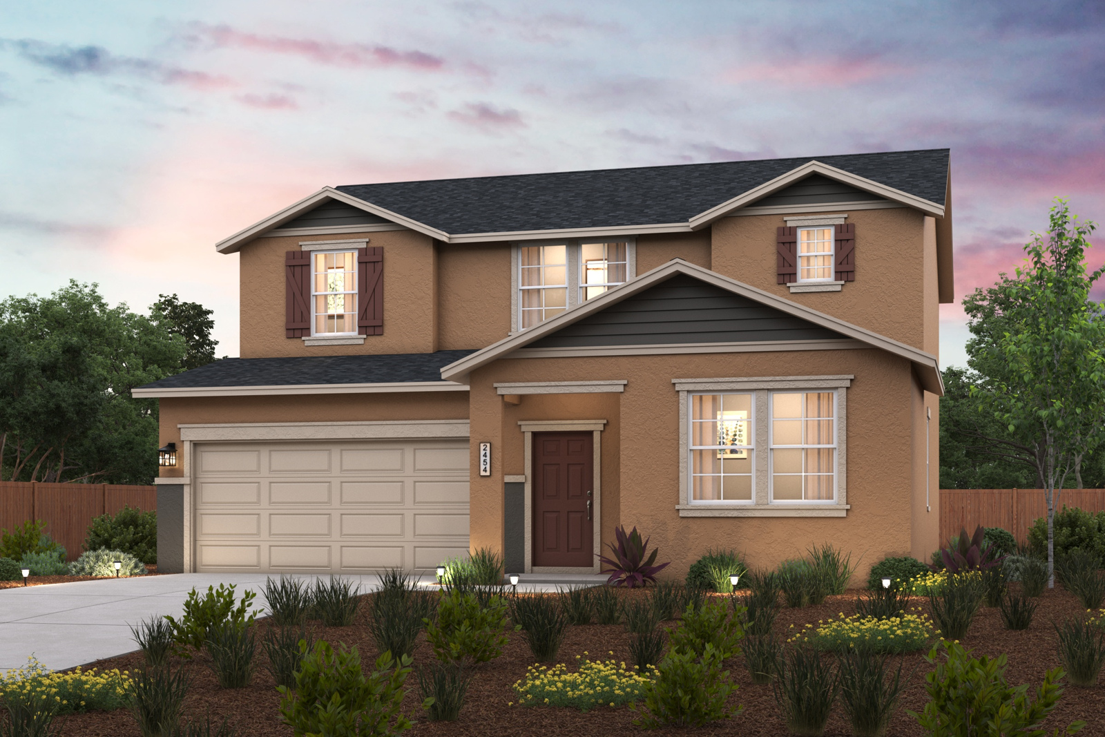 A house with a garage and a garden in front of it.