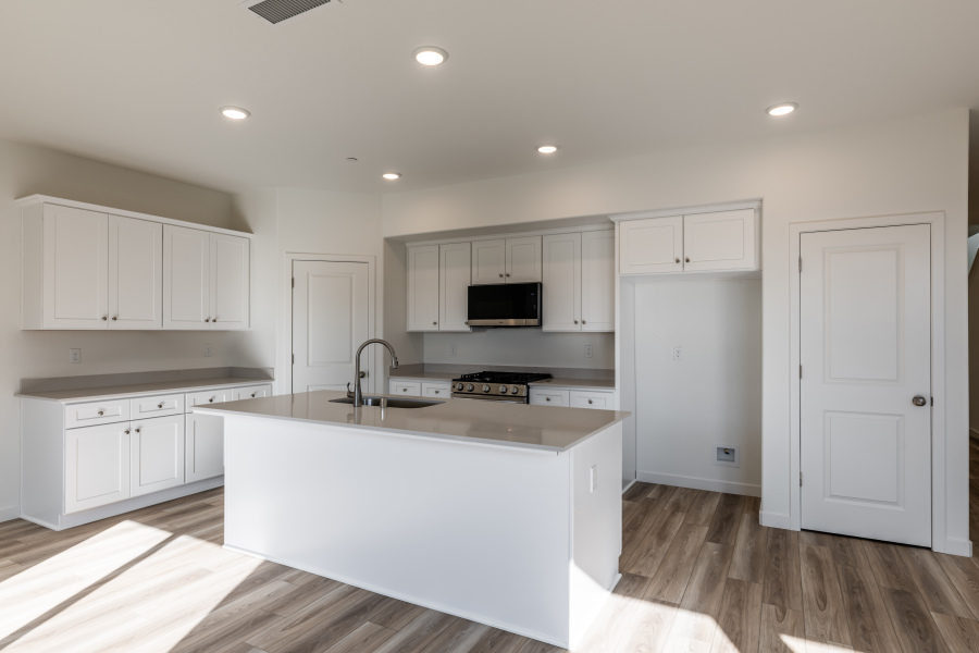 A kitchen with white cabinets.
