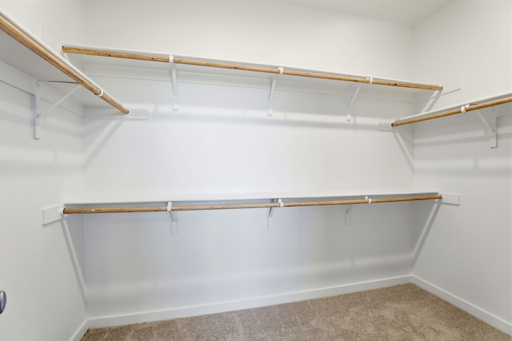 A white wall with a metal bar.