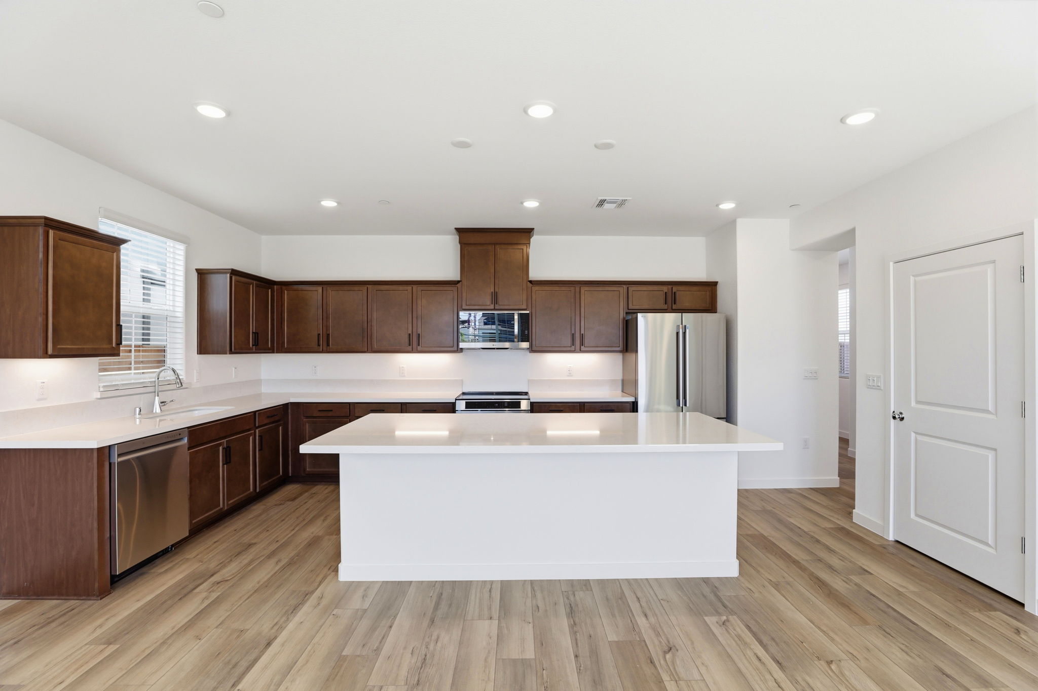 A kitchen with wooden cabinets.