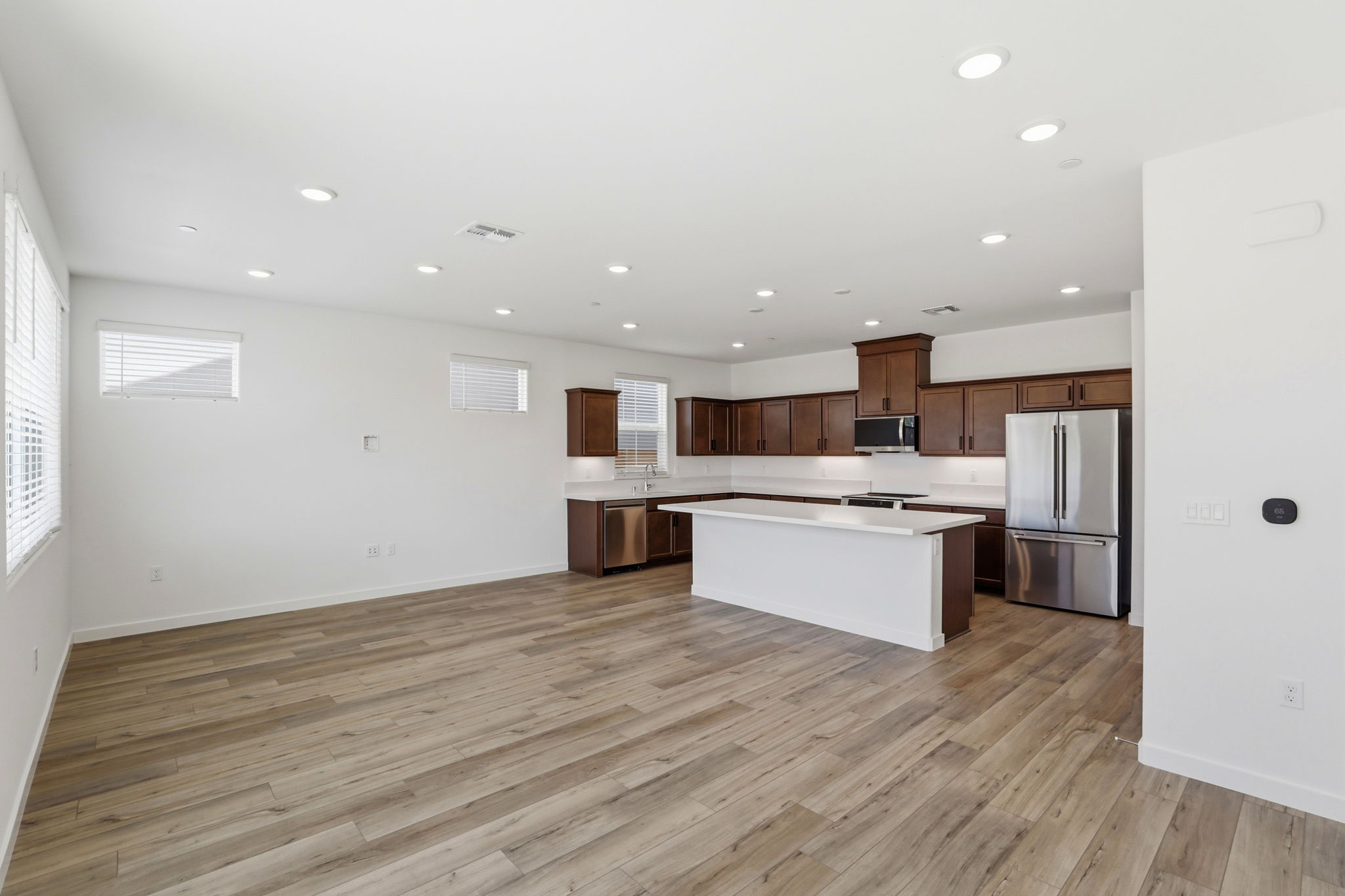 A large kitchen with wooden floors.