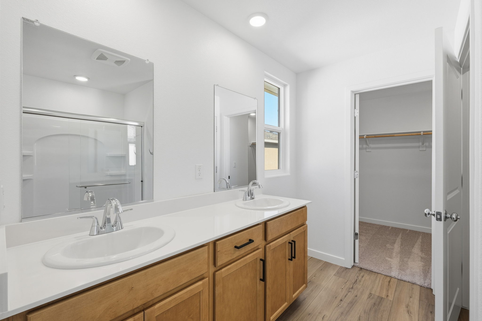 A bathroom with a large mirror.