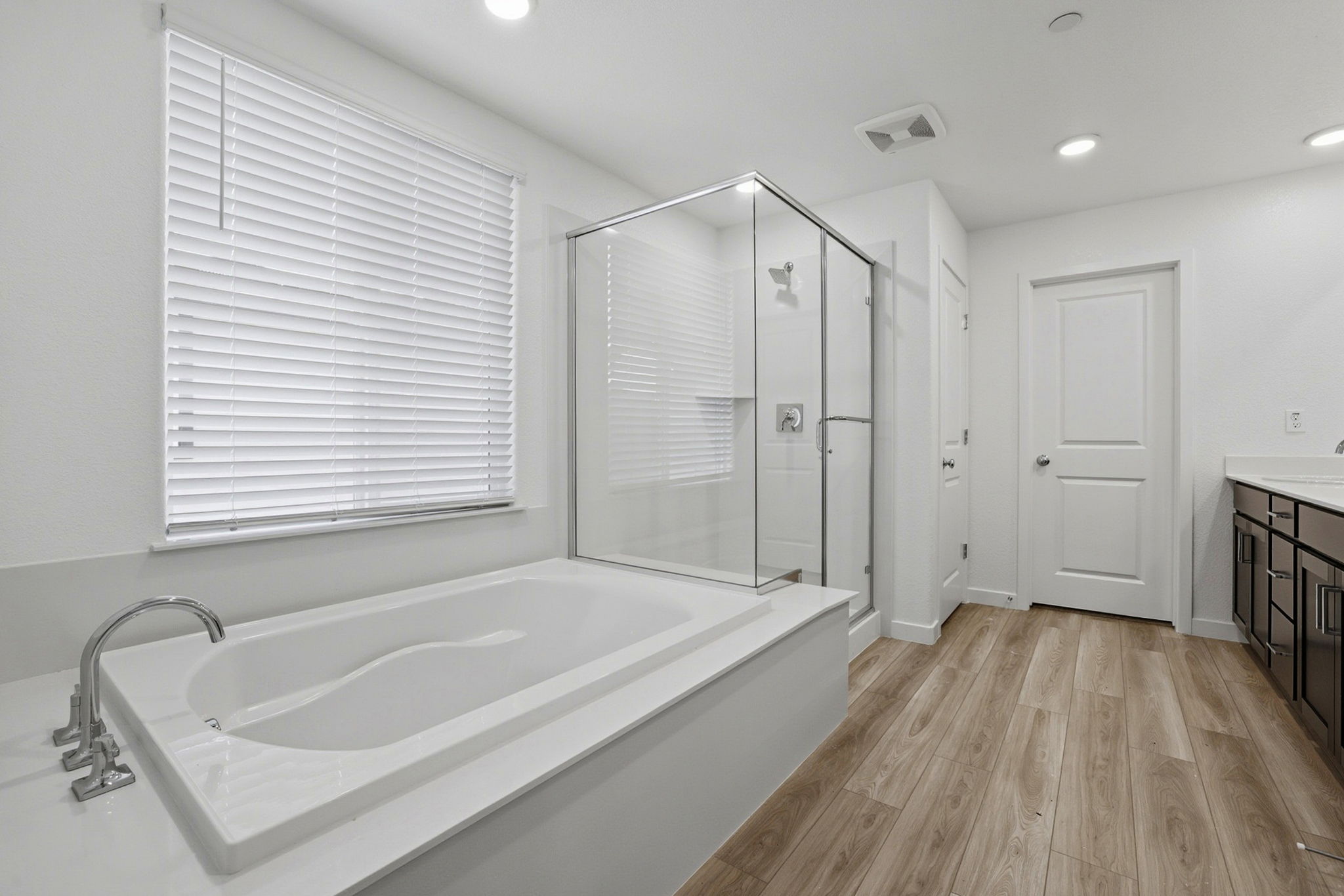 A bathroom with a tub and shower.