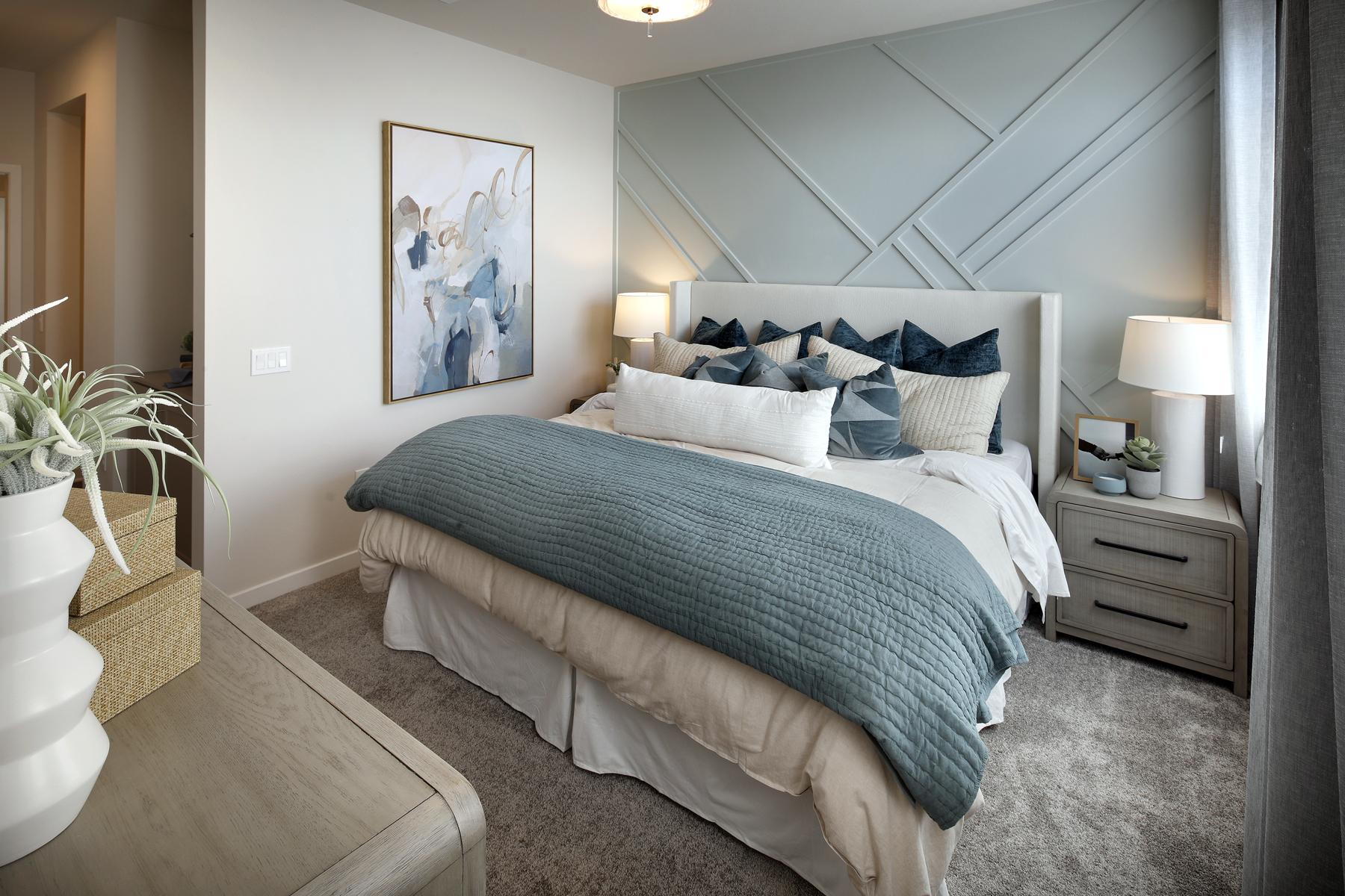 A bedroom with a bed and lamps.