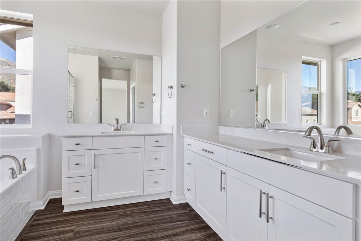 A bathroom with white cabinets.