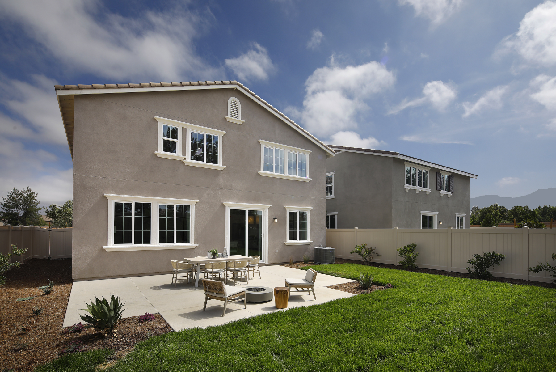 A house with a lawn and tables.