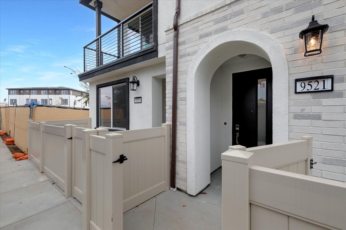 A white building with a black bird on the roof.