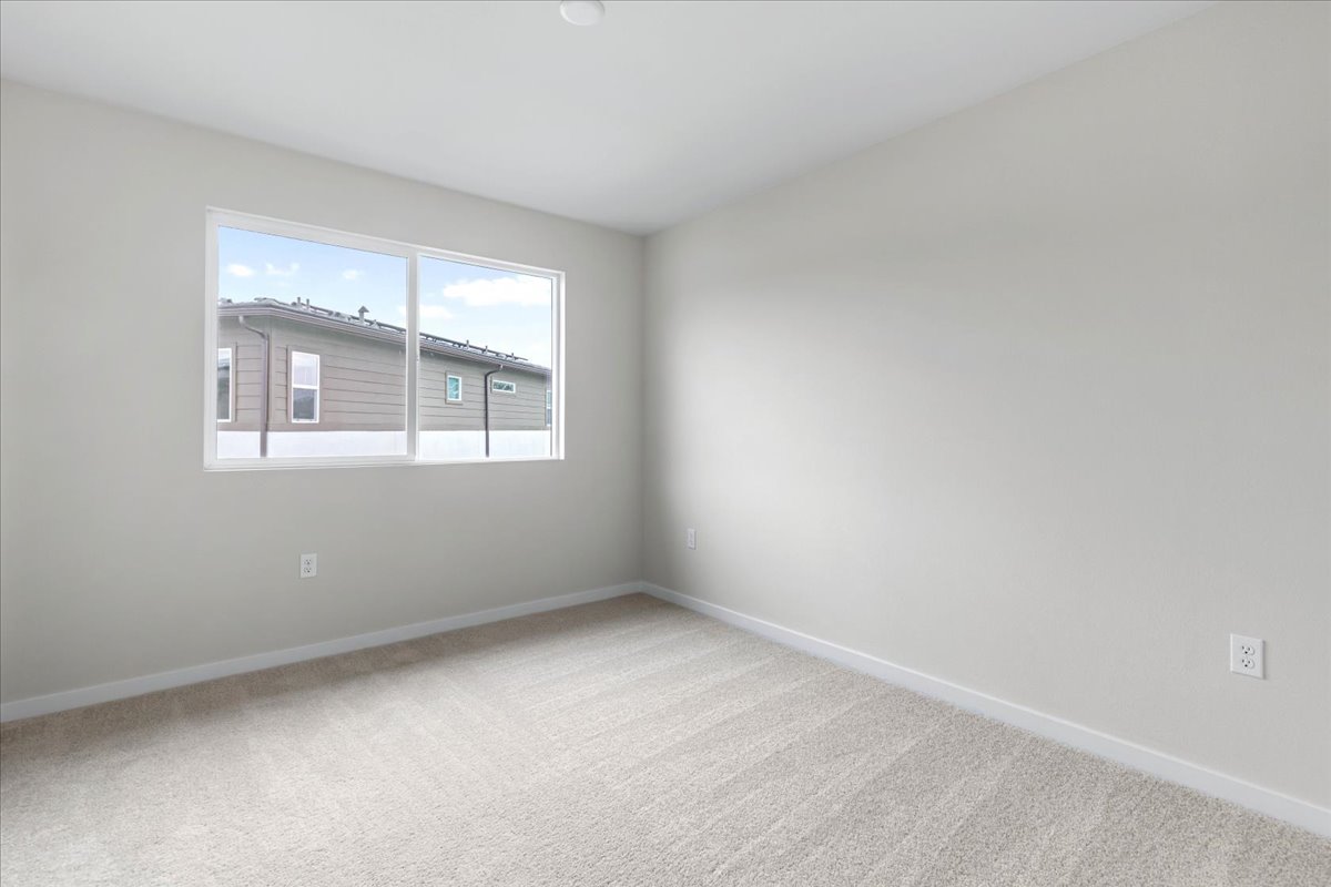 A room with a window and a carpet.