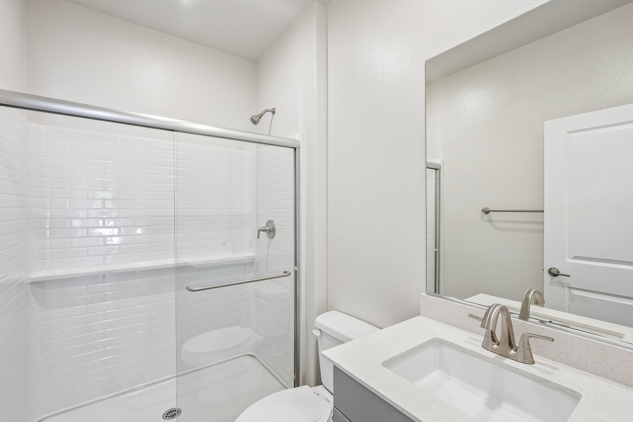 A bathroom with a glass shower.