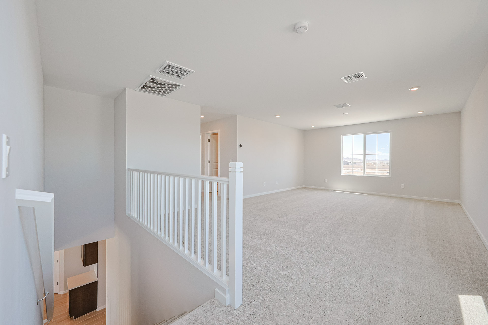 A room with a white railing and a white railing.