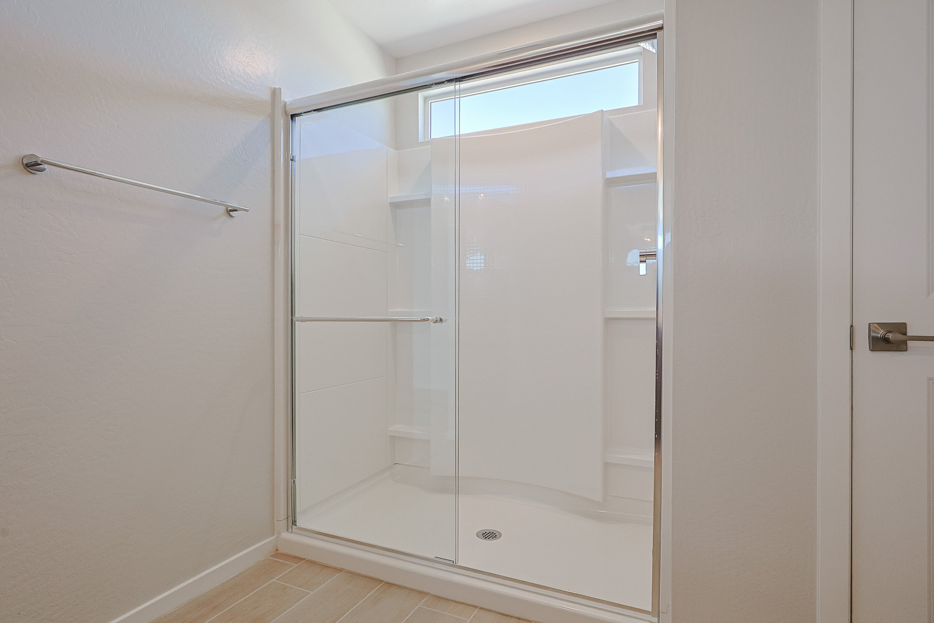 A shower with a glass door.
