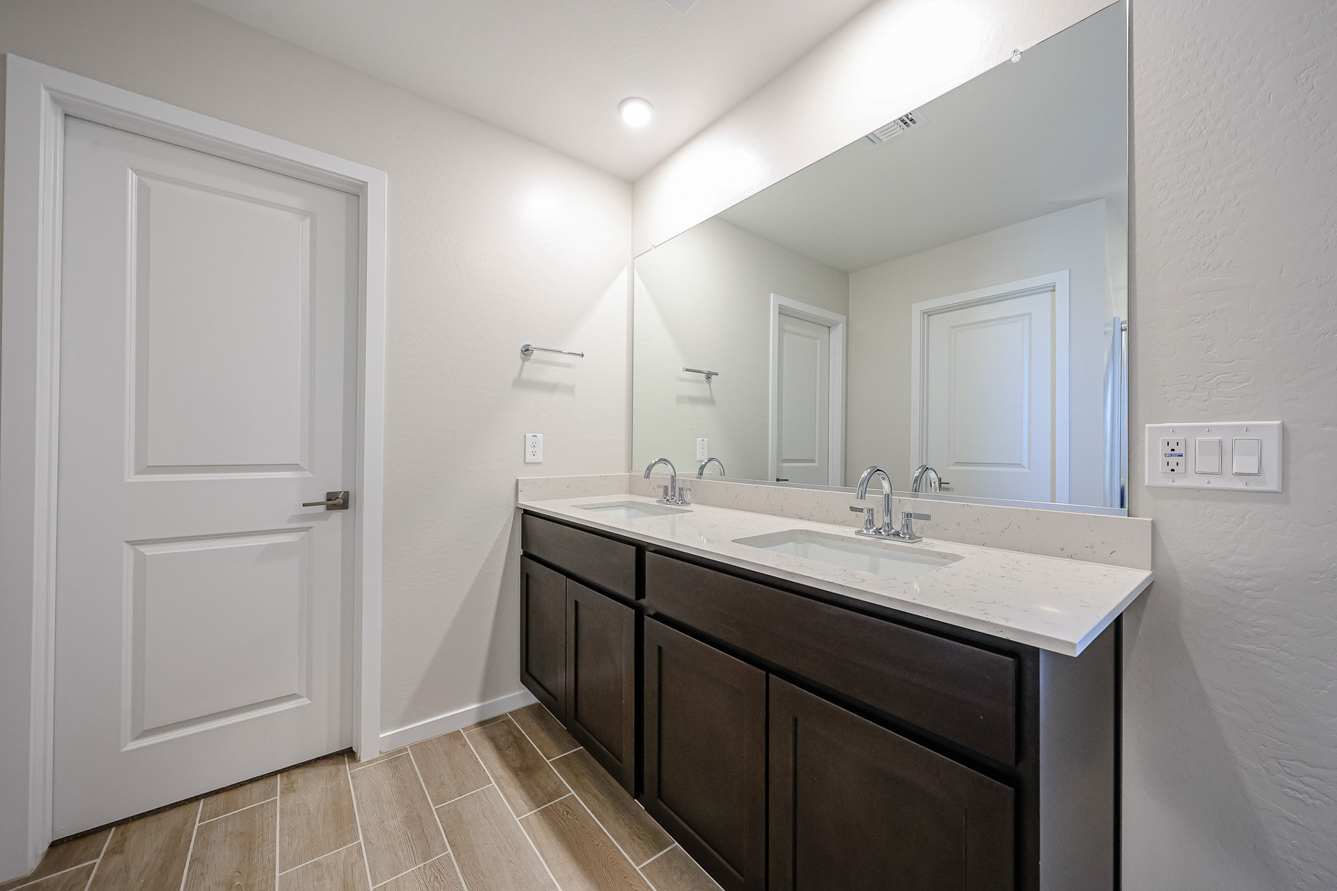 A bathroom with a large mirror.