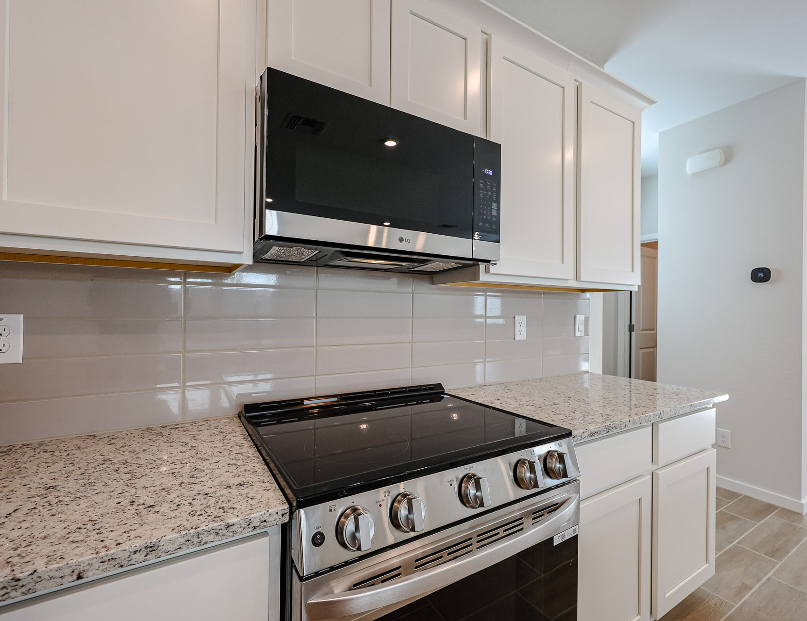 A kitchen with white cabinets.