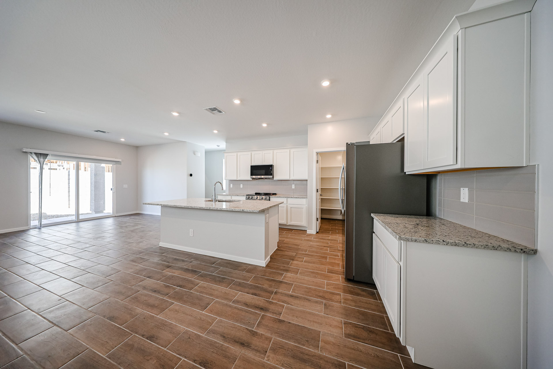 A kitchen with white cabinets.