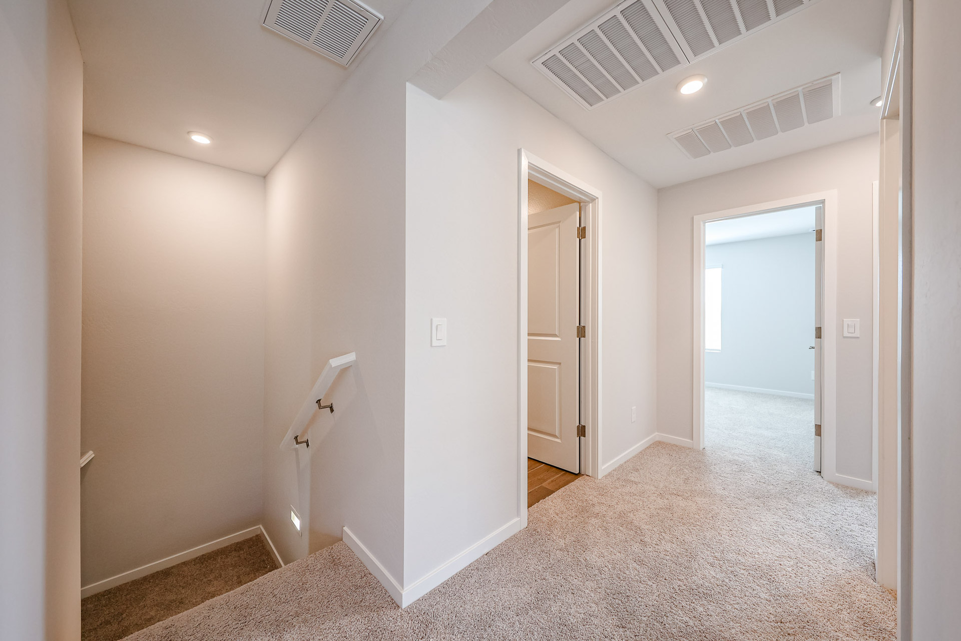 A hallway with white walls.