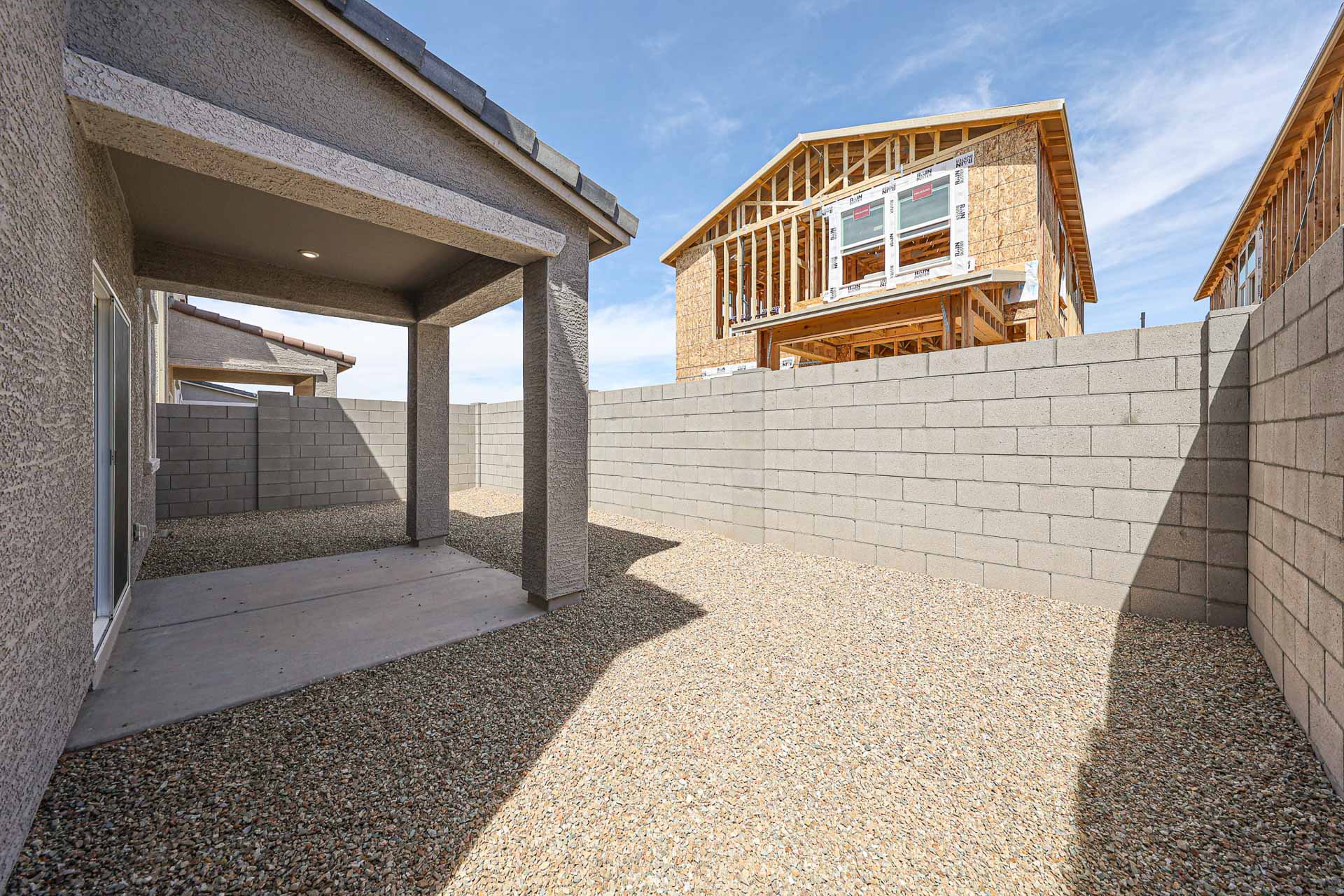 A stone wall with a house on top of it.