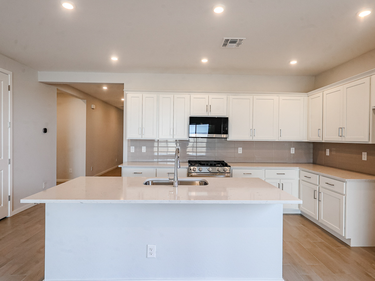 A kitchen with white cabinets.