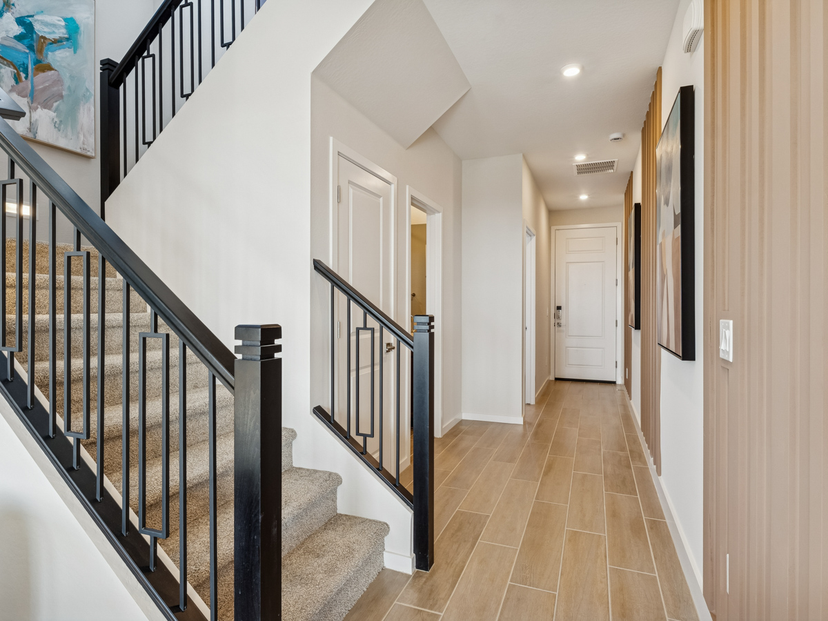 A long hallway with white doors.