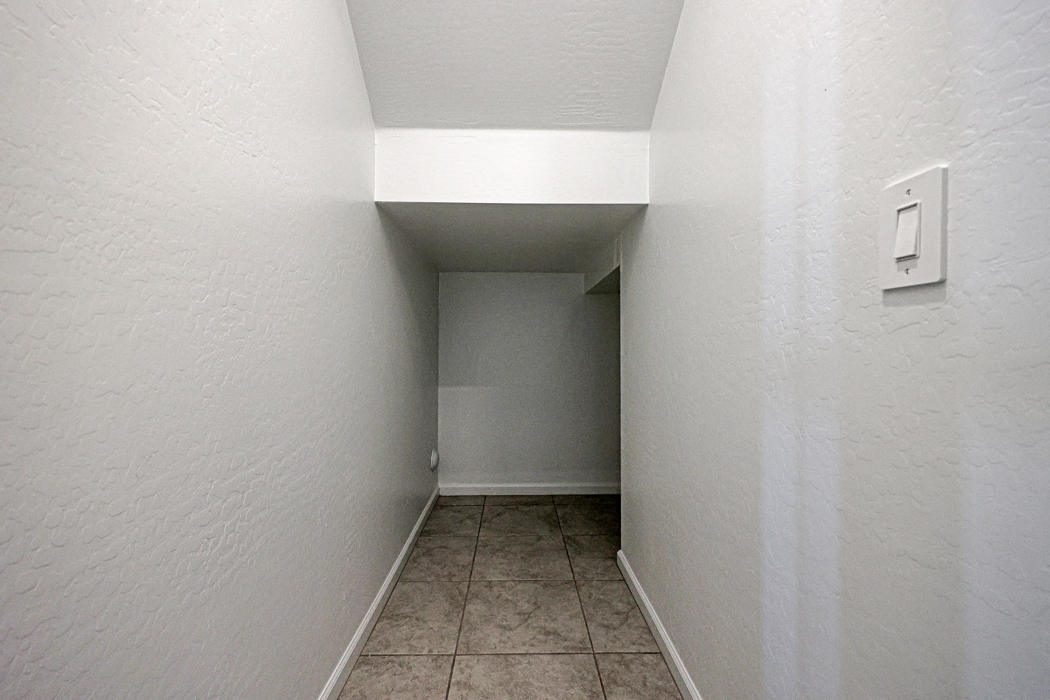 A hallway with white walls.
