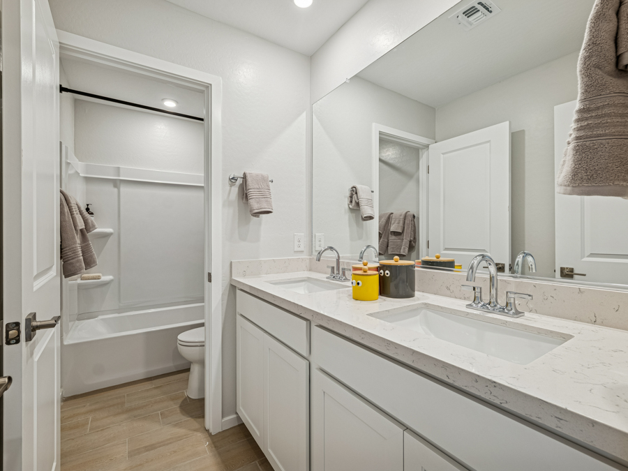A bathroom with a sink toilet and shower.