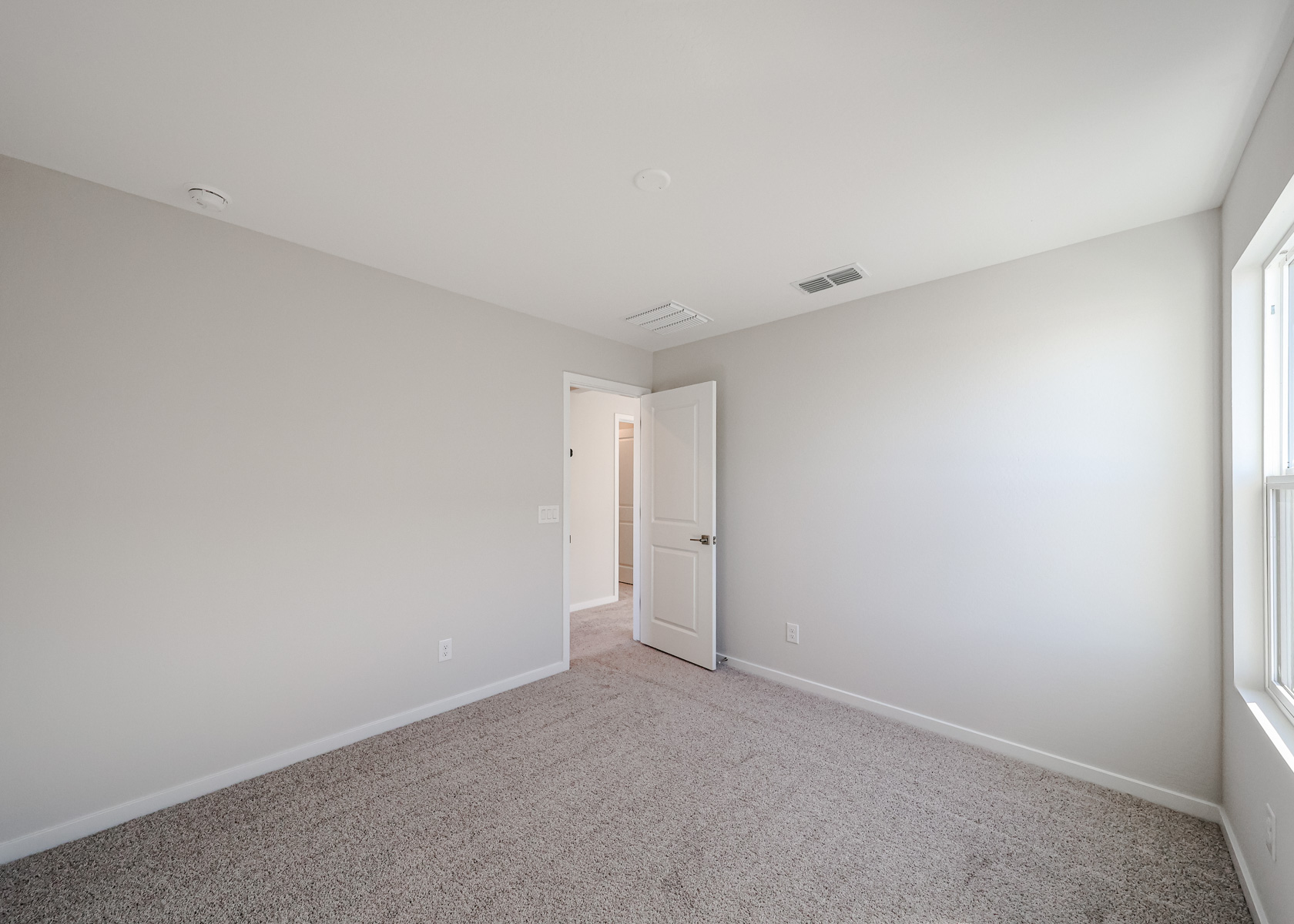 A hallway with white walls.