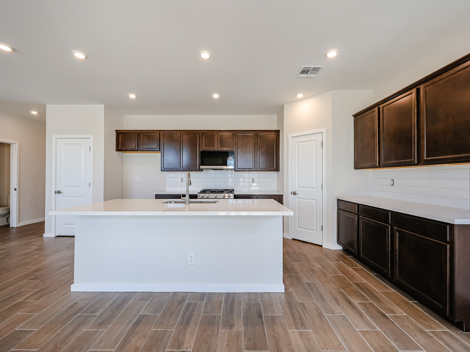 A kitchen with wooden cabinets.
