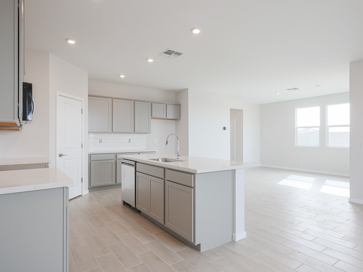 A kitchen with white cabinets.
