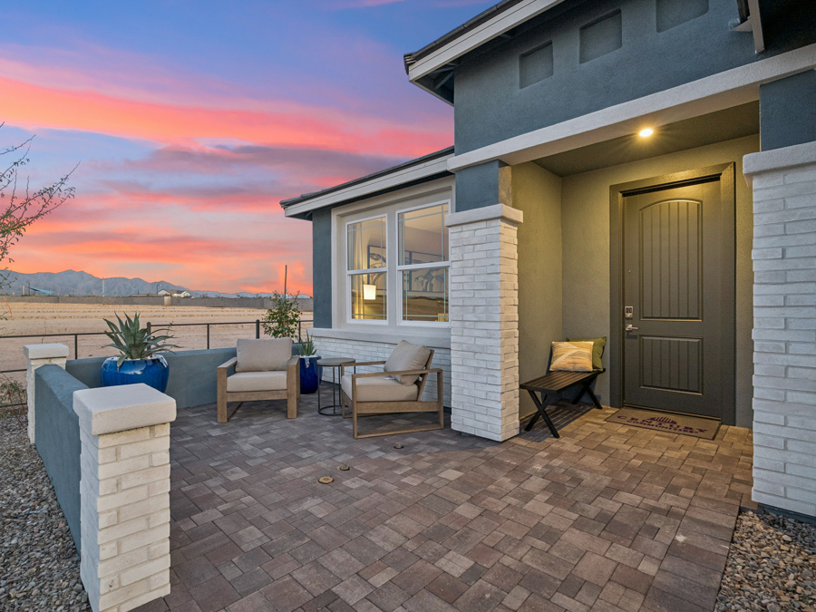 A patio with chairs and a table.
