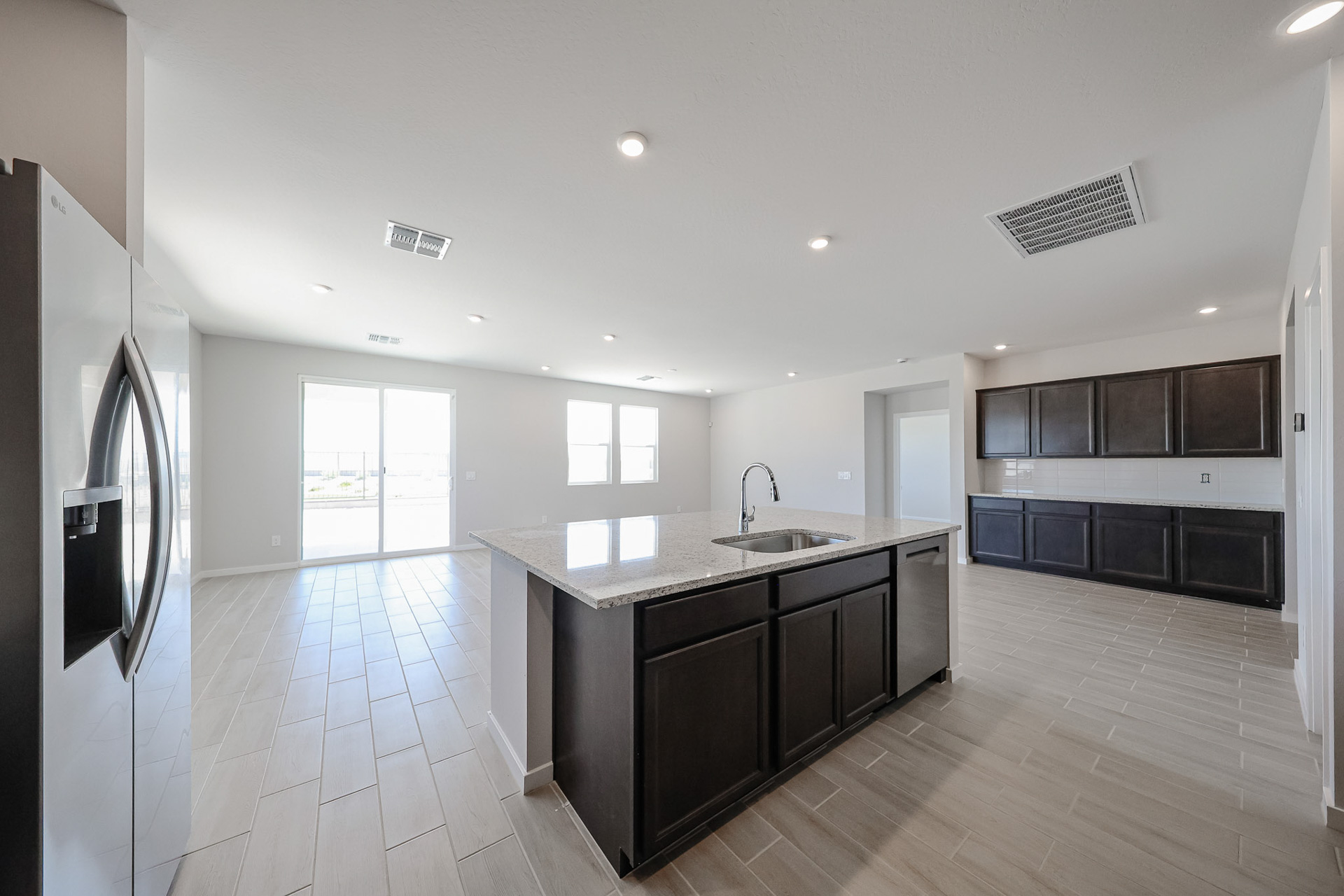 A kitchen with black cabinets.