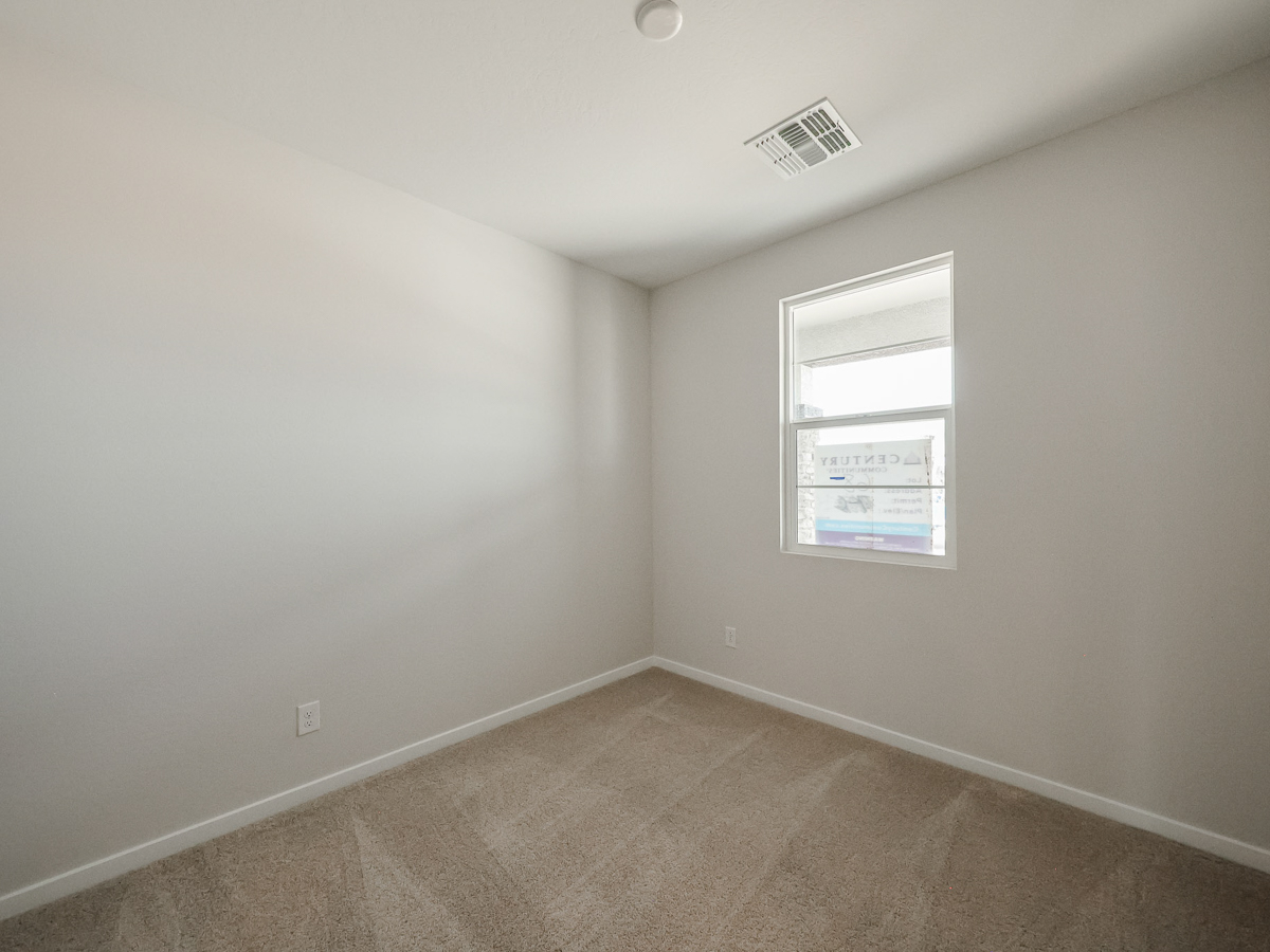 A room with a window and a sign on the wall.