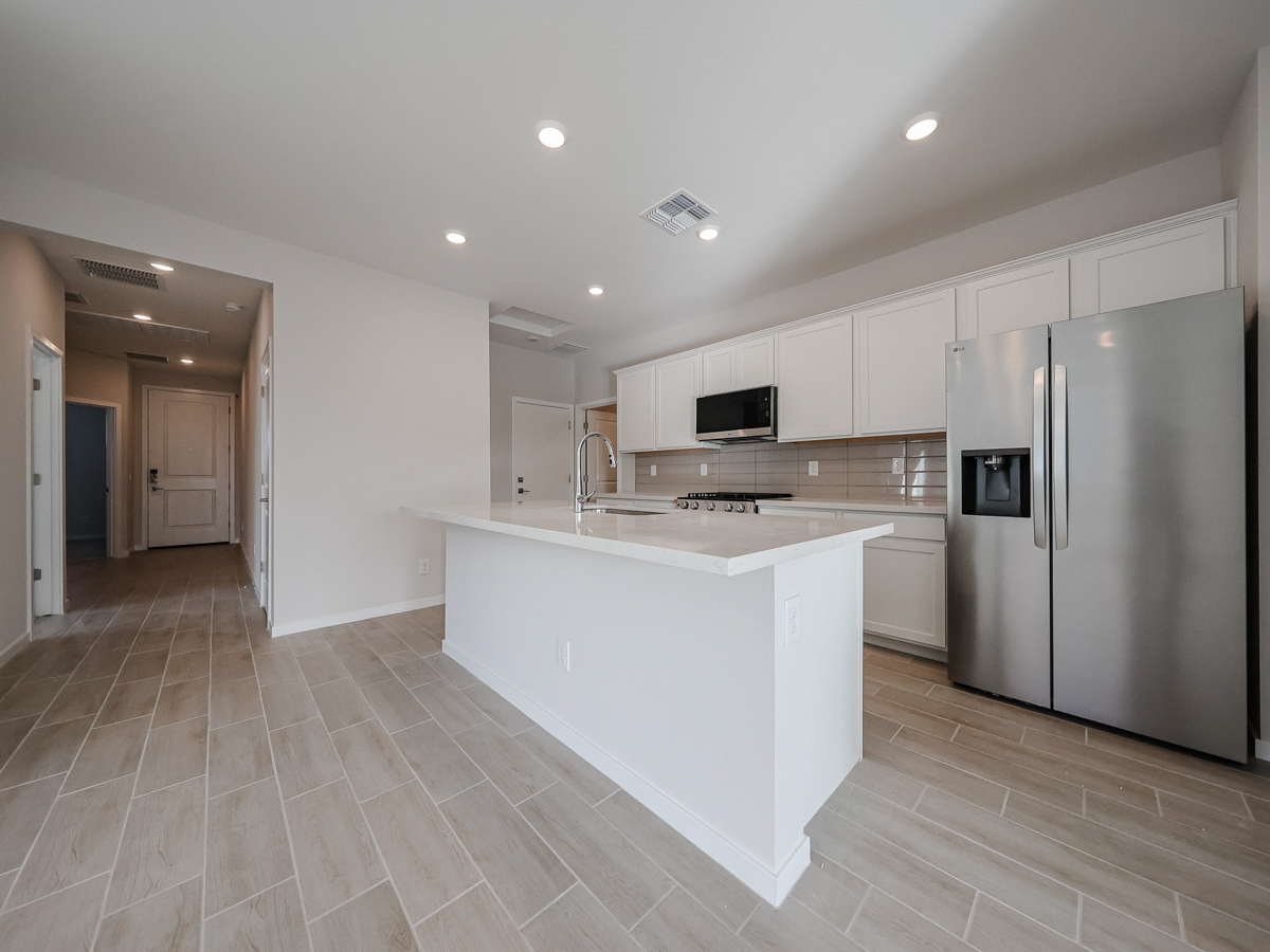 A kitchen with white cabinets.