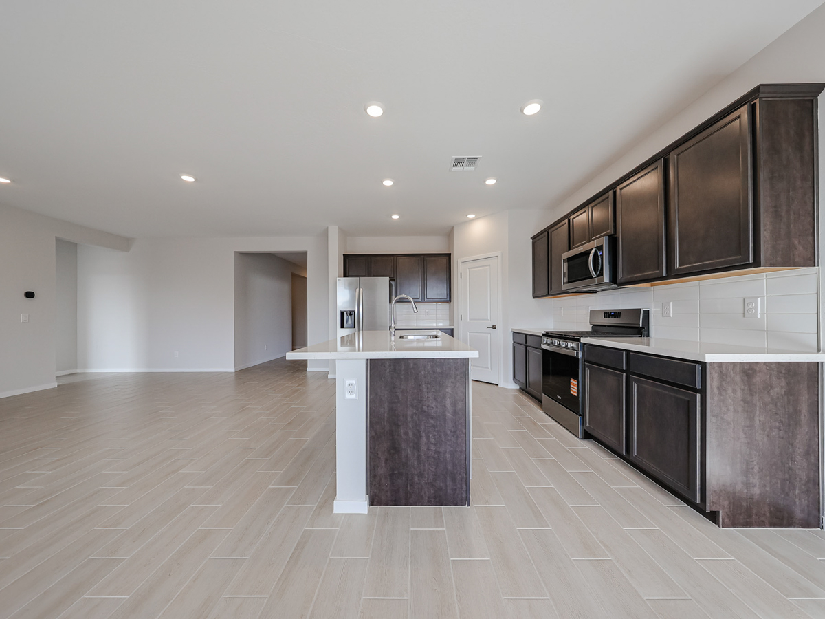 A kitchen with black cabinets.