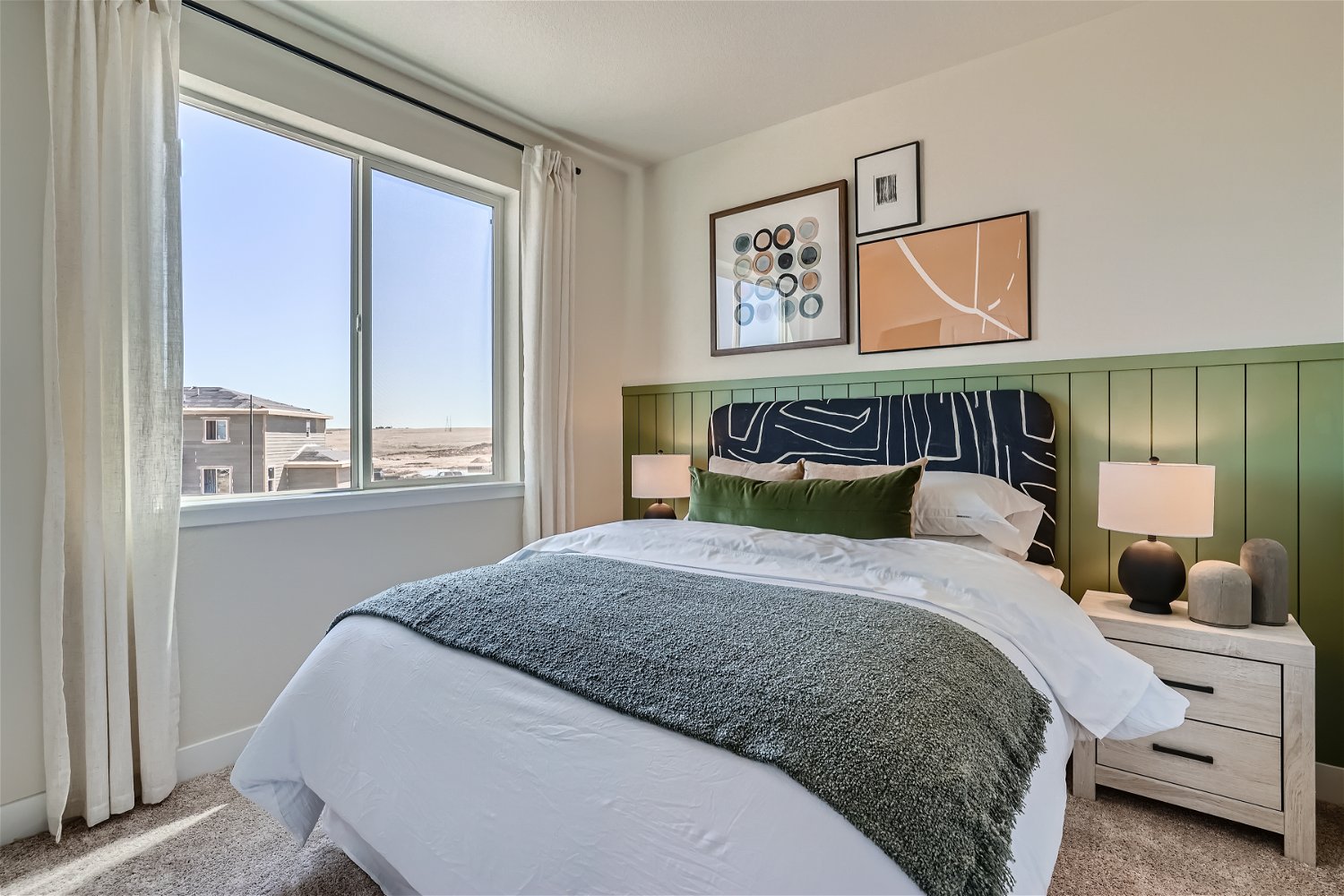 A bedroom with a large window.