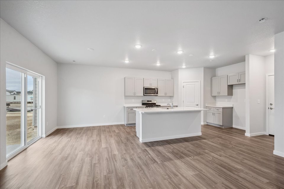 A large kitchen with white cabinets.