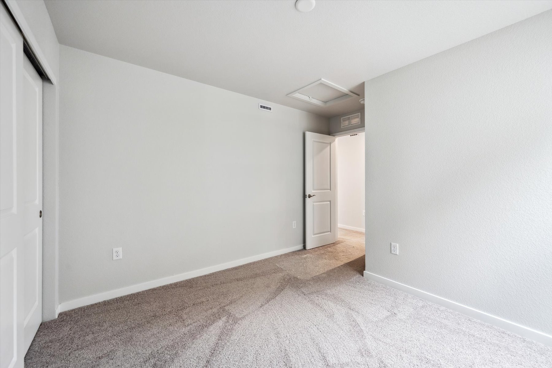 A hallway with white walls.