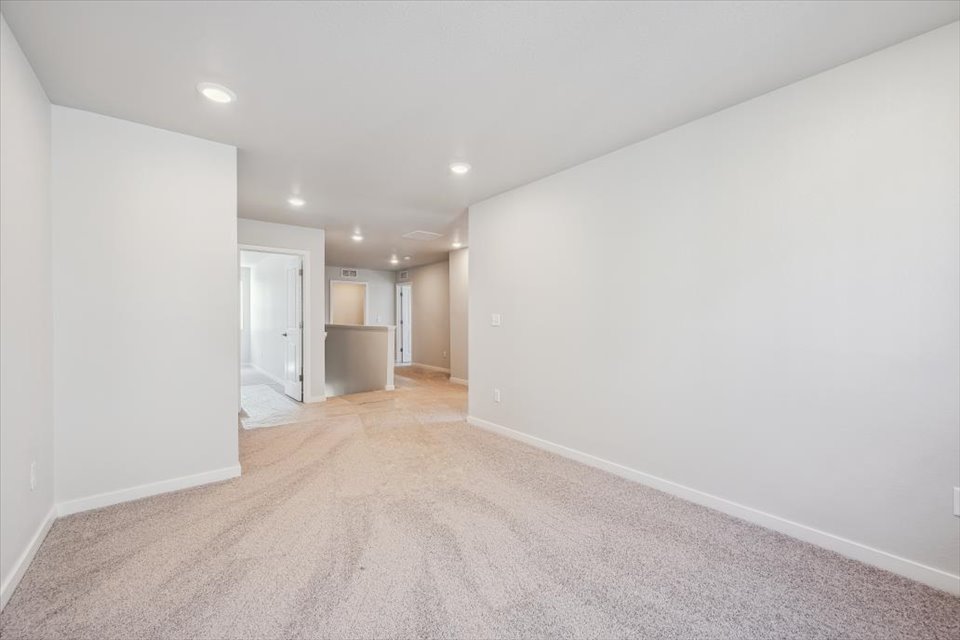 A long hallway with white walls.