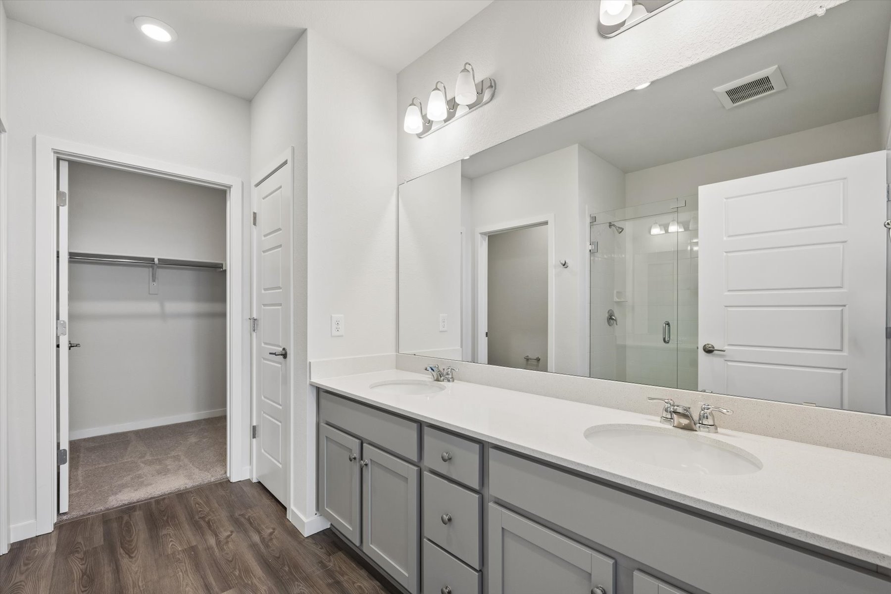 A bathroom with a large mirror.