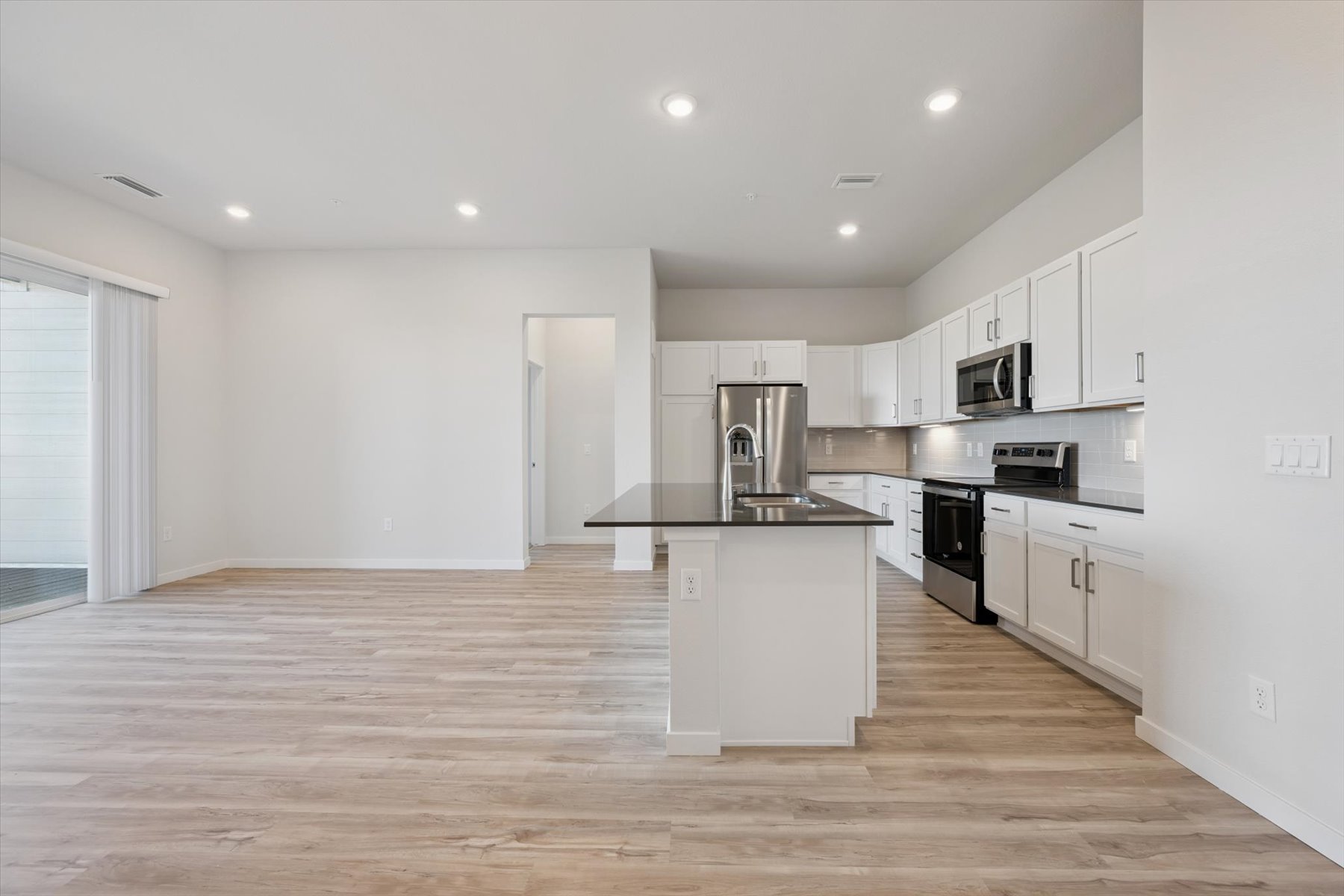 A kitchen with white cabinets.