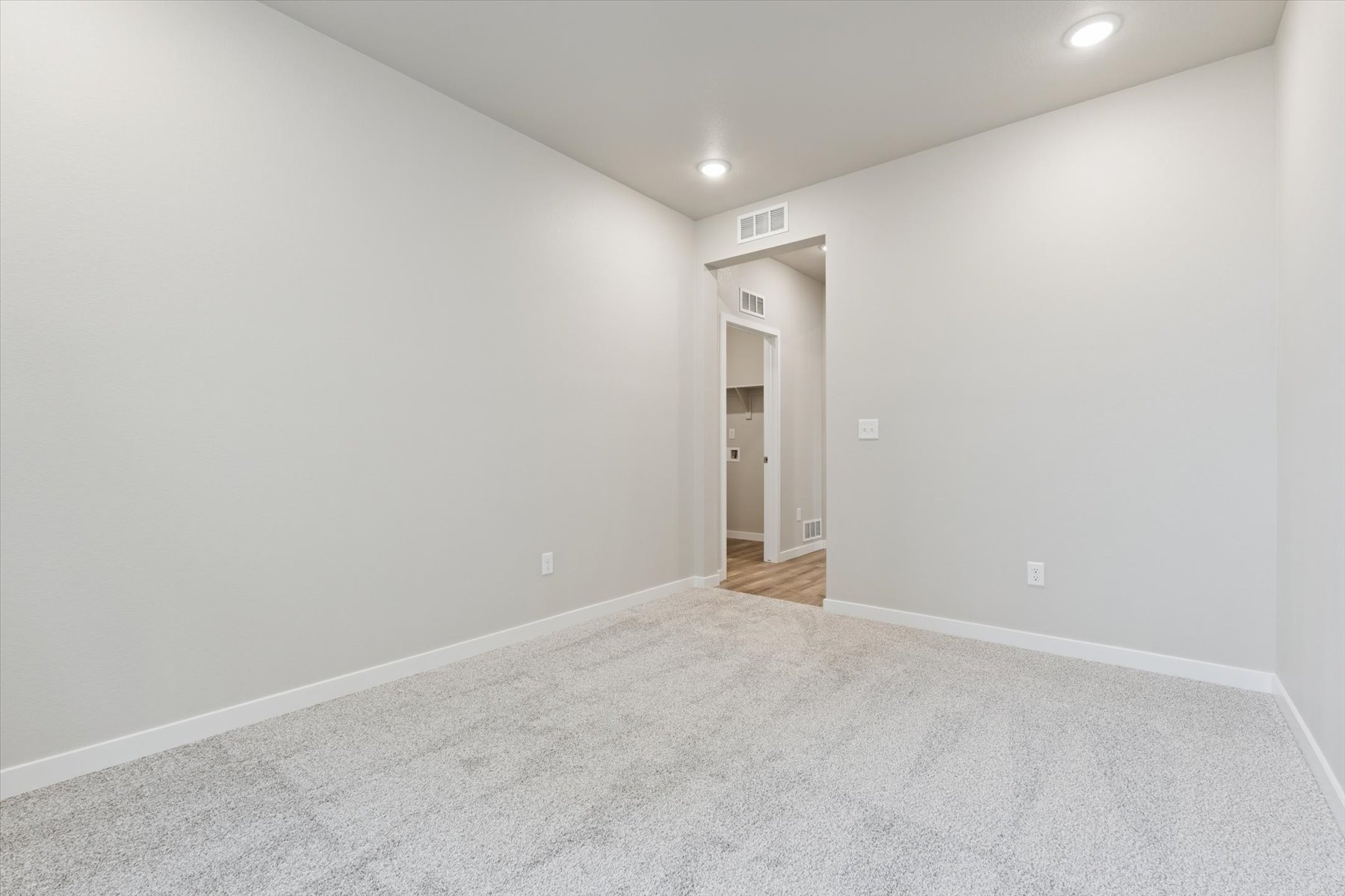 A hallway with a door.