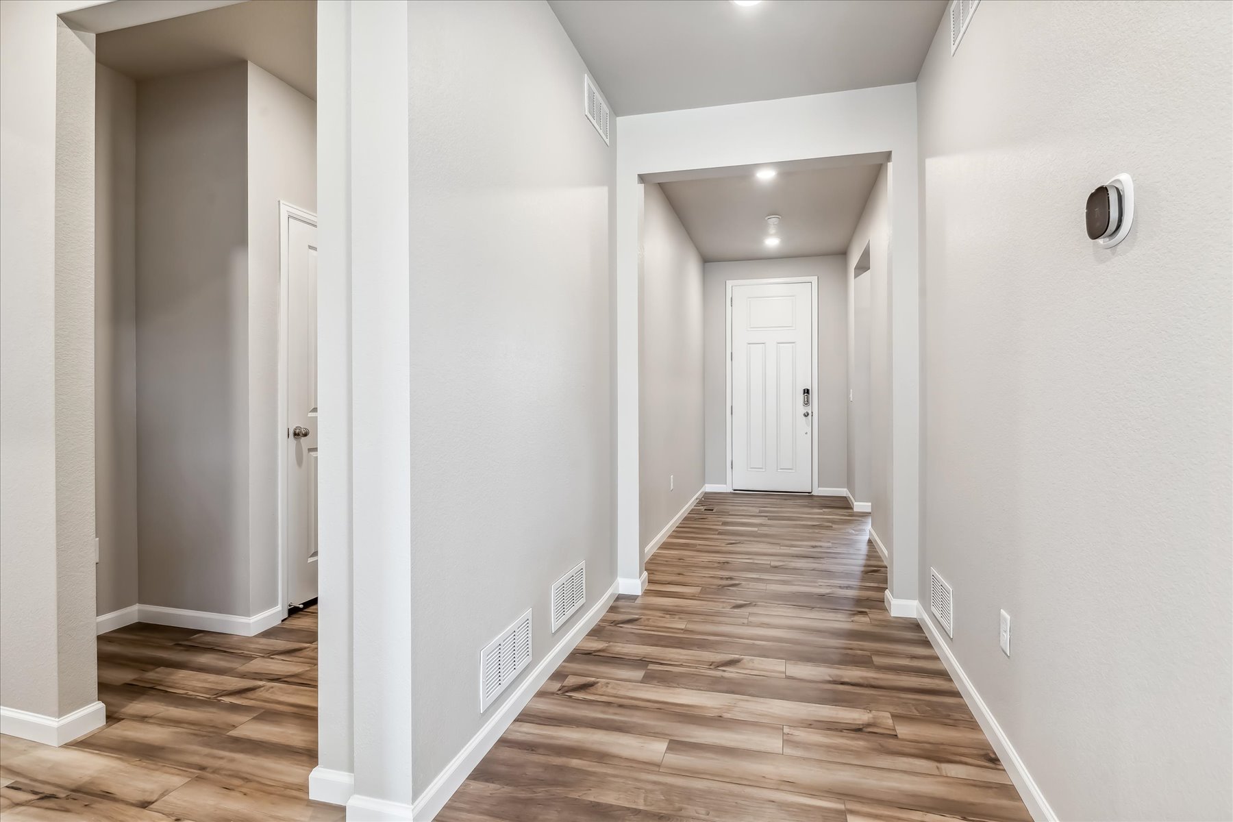 A hallway with white walls.