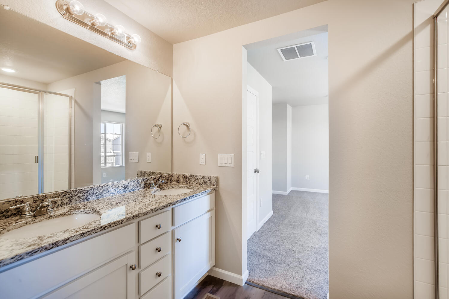 A bathroom with a marble countertop.