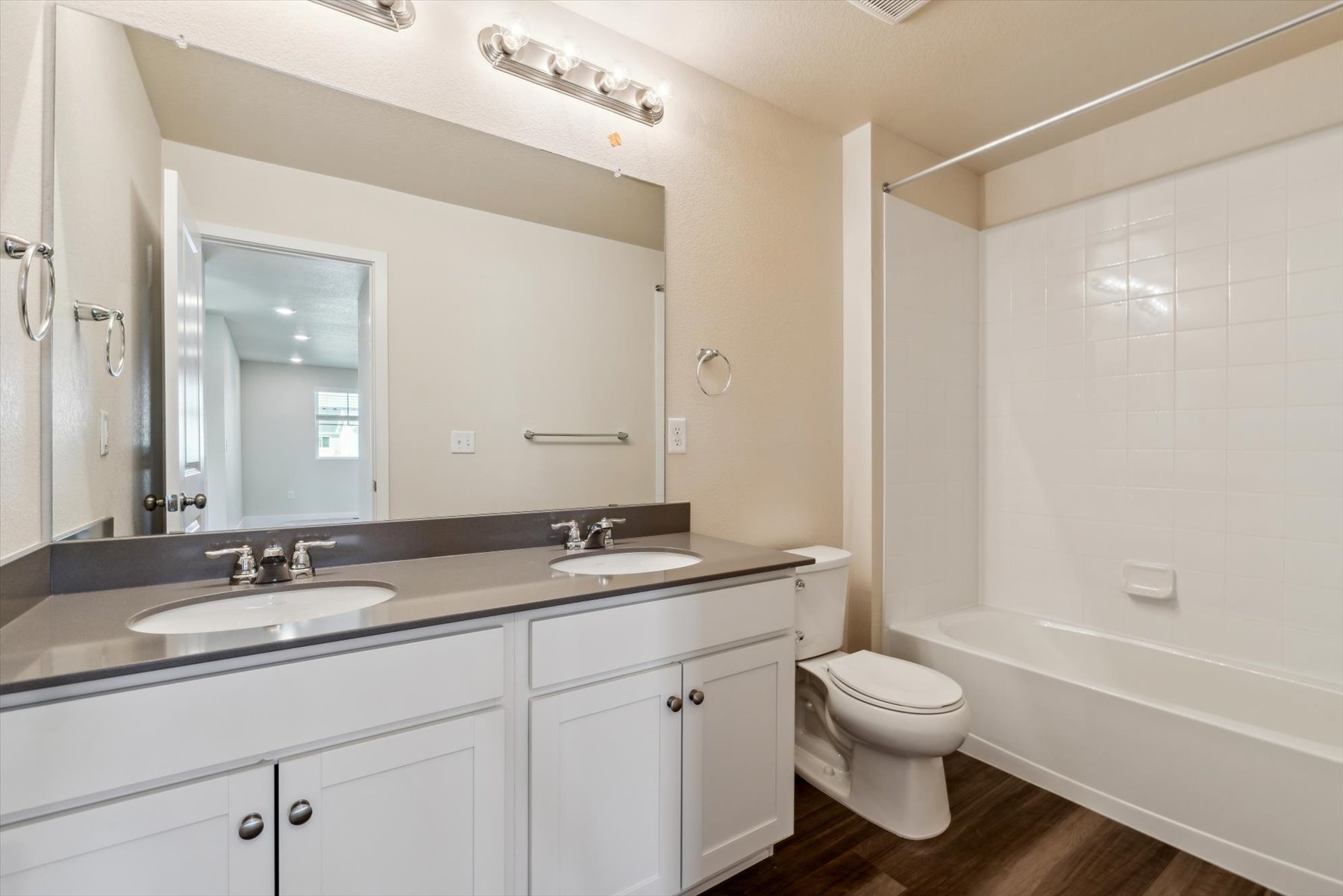 A bathroom with a tub sink and toilet.