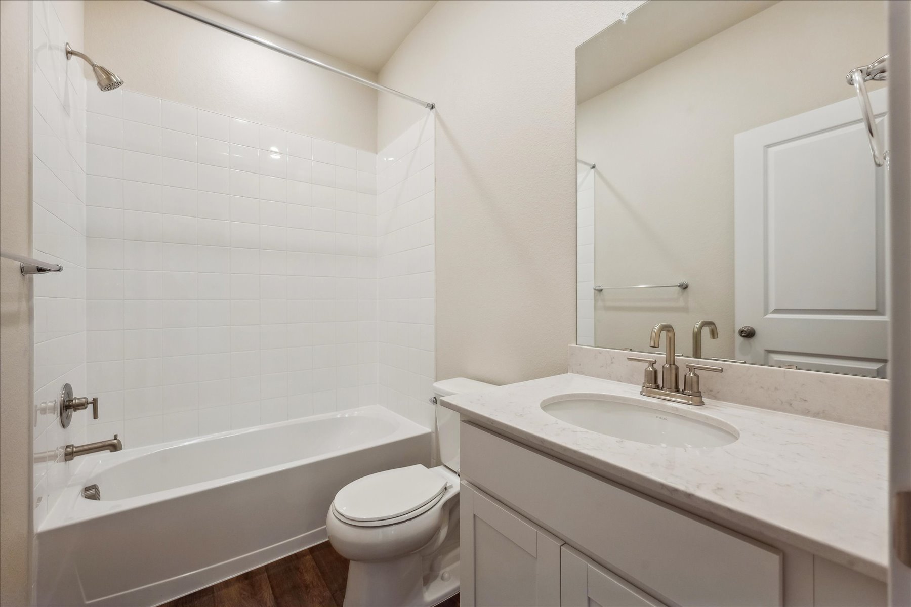 A bathroom with a tub sink and toilet.